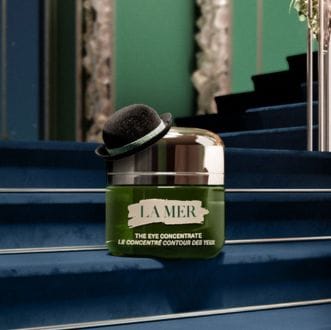 Close up of model applying The Eye Concentrate to under eyes using applicator